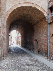 Fototapeta na wymiar Ferrara, Italy. Downtown, ancient archway.