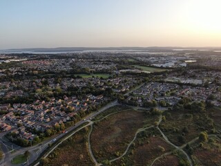 aerial view of Canford Heath in Poole UK showing modern housing, remaining heathland with Poole harbour in the background.