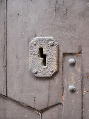 Wooden door, old rusty lock. Detail, keyhole.