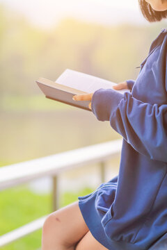 Blur image , A young woman is reading and learning the teachings of God from the Bible that she holds in her hand, with faith and faith in God making her determined to learn all of His teachings.