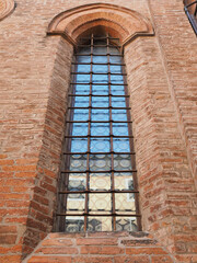 Fototapeta na wymiar Ferrara, Italy. Former saints Simon and Jude church. It was a parish church in 1228, it was rebuilt in late Gothic style in 1422. One of the pointed arched windows on the facade.