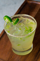 Margarita. Classic traditional Mexican cocktail. Made with Blanco tequila, fresh lime juice, agave syrup and orange juice. Served in salt rimmed tumbler over ice and garnished with a lime.