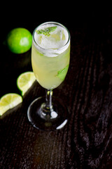 Margarita. Classic traditional Mexican cocktail. Made with Blanco tequila, fresh lime juice, agave syrup and orange juice. Served in salt rimmed tumbler over ice and garnished with a lime.