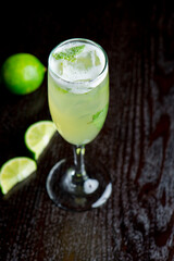 Margarita. Classic traditional Mexican cocktail. Made with Blanco tequila, fresh lime juice, agave syrup and orange juice. Served in salt rimmed tumbler over ice and garnished with a lime.