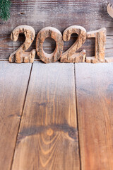Wooden numbers 2021 on wooden table, christmas background, space to write text