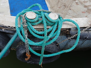 Fishing boat. Colored rope and tire that acts as fenders. 