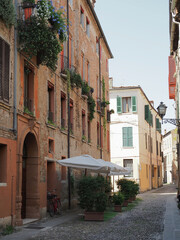 Ferrara, Italy. Old town, sunny medieval street, without people.