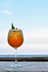 Vertical view, Orange juice in a tall glass on a marble table.