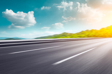 Motion blurred asphalt road and green mountain under blue sky. © ABCDstock