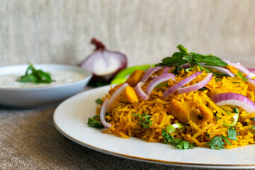 Delicious chicken biryani with raita sauce