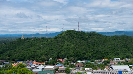Mountain view with signal towers of various communications. Which is surrounded by residential...
