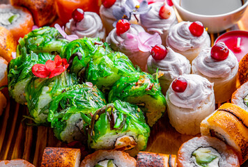 set of sushi roll with salmon, avocado, cream cheese, cucumber, rice, caviar, eel, tuna on wooden table