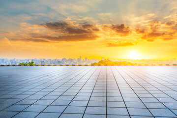 Empty square floor and city skyline with buildings in Hangzhou at sunrise.