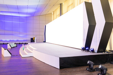 Empty conference hall with empty white projector screen