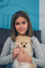 portrait of little girl holding puppy