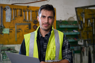 Smart caucasian engineer smile portrait with laptop and industrial manufacturer site