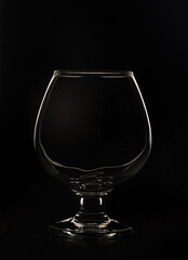 Cognac glass on a black background Empty crystal cognac glass on a black background.