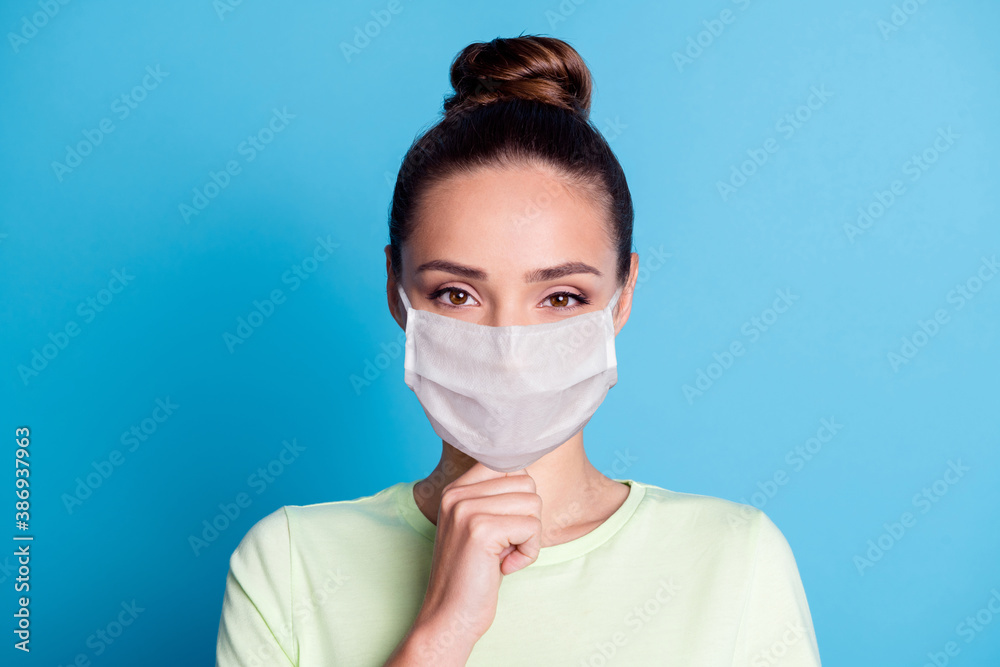 Sticker Portrait of pretty nice girl touch finger chin look in camera wear medical mask isolated over blue color background