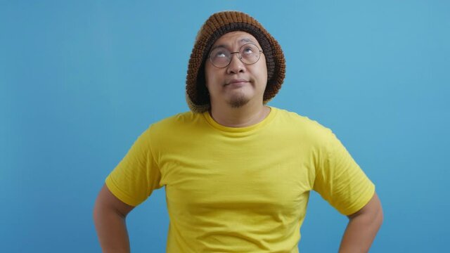Young Asian man shows disappointed upset gesture