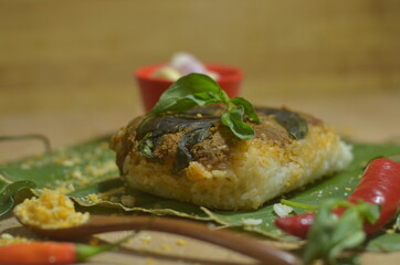 Baked Rice or Nasi Bakar / Nasi Lemak food product on wooden texture background