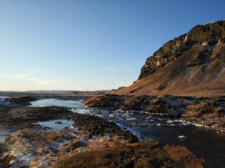 Iceland's breathtaking mountain landscape in winter, a river with a waterfall. Nature paints
