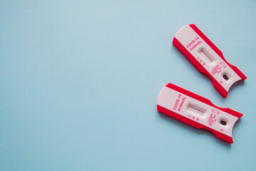 Two Covid-19 clean tests on the right. Blue background. Copy space