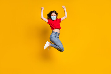 Fototapeta na wymiar Full length photo of ecstatic girl jump win raise fists wear mask isolated over bright shine color background
