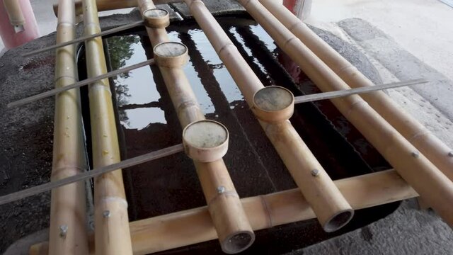 Traditional bamboo made Hishaku at water basin in shrine in Hinomisaki / Izumo area, Shimane, Japan
Hishaku is Japanese traditional ladle to use to scoop out the water for purification