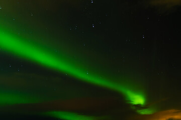 Fototapeta na wymiar Northern lights in the night sky of iceland. Soft focus. Magical green glow.