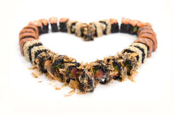 Macro of black rice sushi rolls set isolated on on white background. Sushi served in food heart shape. Copy space , food isolation for Japanese meal menu
