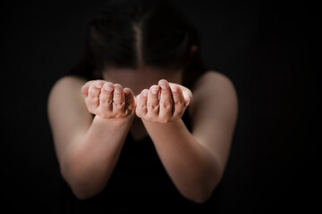 Woman's hand praying and worship to GOD Using hands to pray in religious beliefs and worship christian in the church or in general locations in vintage color tone or copy space.