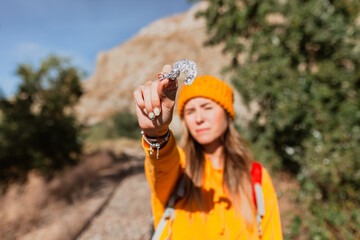 Woman trekking near train tracks picks up trash in nature. Environmental concept