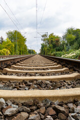 Fototapeta na wymiar Close-up of railroad tracks leading straight forward to infinity