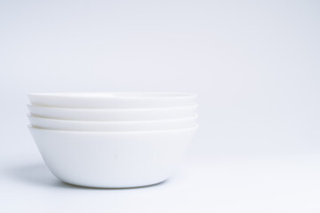 Blurry image of three small white bowls isolated on white background include clipping path