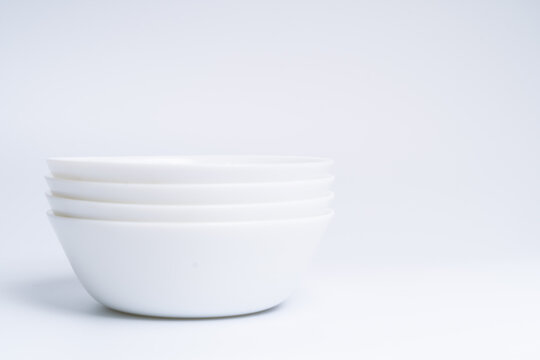 Blurry image of three small white bowls isolated on white background include clipping path