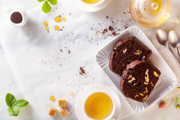 chocolate loaf cake with walnuts and prunes on the table with green tea. pause coffee