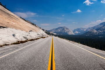 The Tioga Road (highway 120) leading to the Tenaya Lake at the Yosemite National Park, California, USA; Concept for road trip.