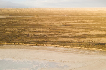 Salt lake with wide flatlands background.