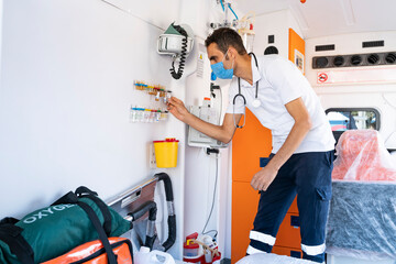 Emergency aid team preparing for emergency response to the patient in the ambulance