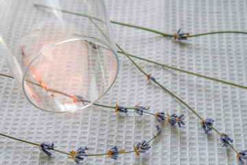 Lavender on a white waffle cotton towel. A sip of rose wine in a glass. Rose wine of Provence concept.