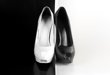 white and black high-heeled shoes on an abstract white and black background