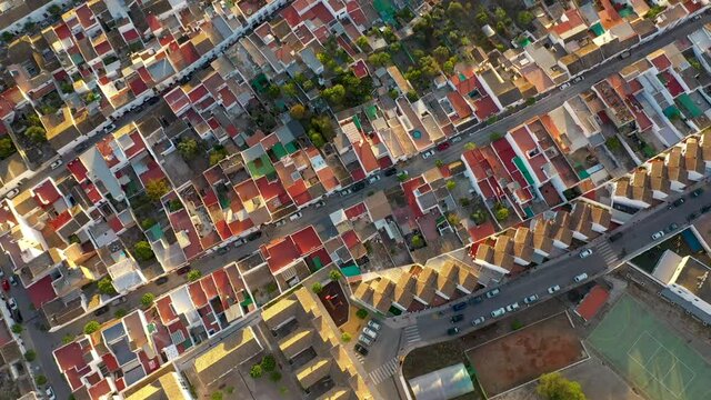 A top-down aerial drone view of the small city of Bornos in Andalucia, Spain during sunrise.