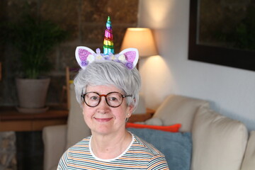 Senior woman wearing fantastic unicorn tiara   © ajr_images
