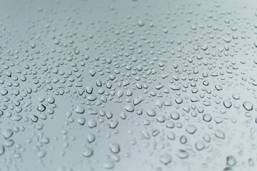 rain drops on a grey window during a thunder storm 