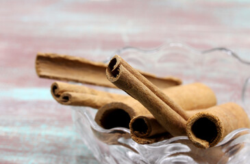 close up of cinnamon sticks on wooden background