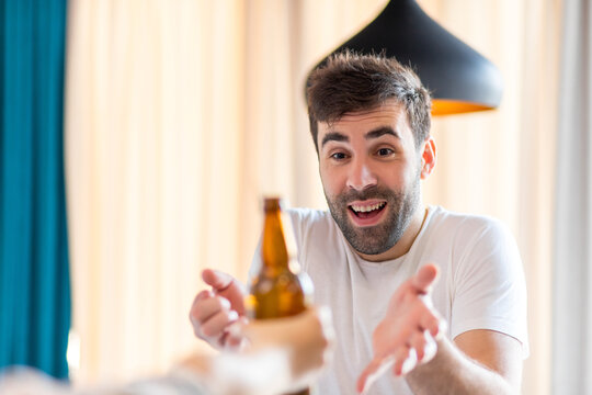 Photo of bearded man happy to get a bottle of bear.