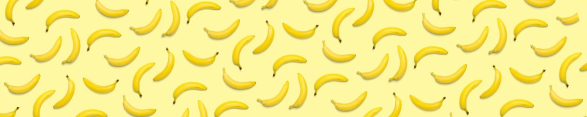 Bananas creative background. pop art bananas background. Tropical abstract background with banana. Colorful fruit yellow banana