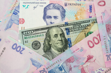 Currency ratio concept. 100 dollar bill and 200 Ukrainian hryvnia.