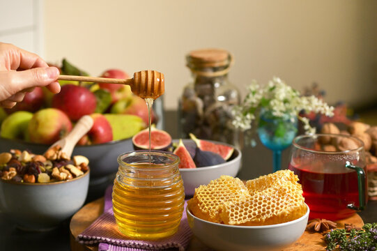 Honey, Honeycomb, Tea, Dried Fruits on Autumn Table