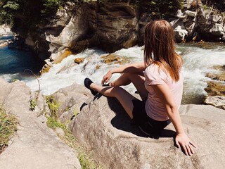 woman sitting on rock